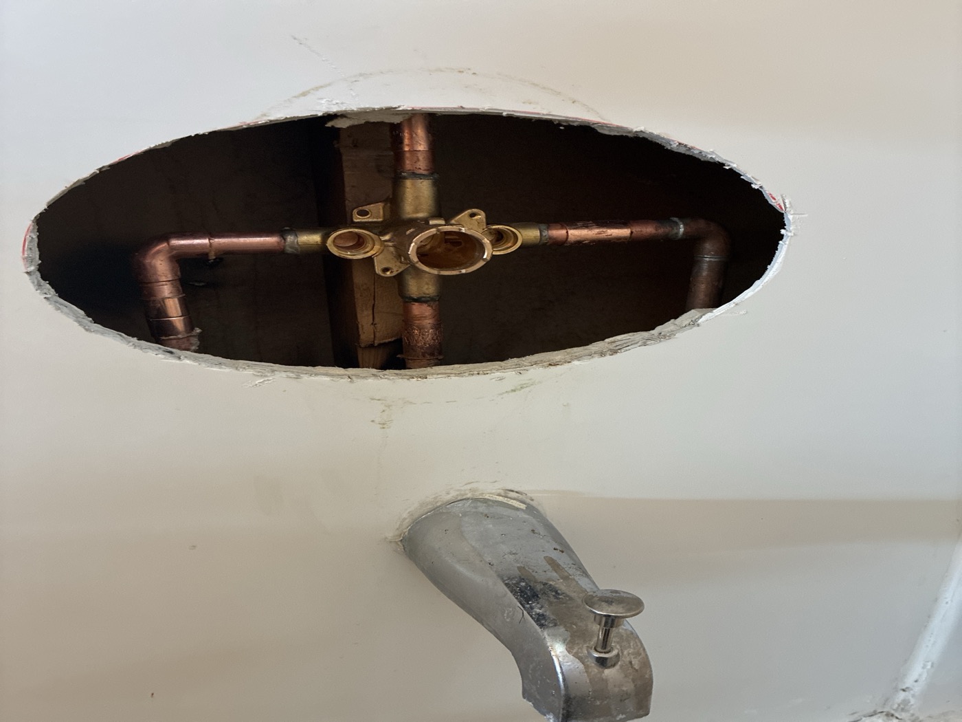 Copper supply lines exposed through a shower wall access opening